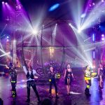 Showing 6 people and a iron cage in the background